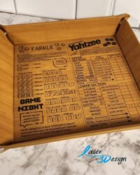 Leatherette dice tray engraved with Farkle and Yahtzee score sheets, shown with snap corners and a set of dice on a marble countertop.